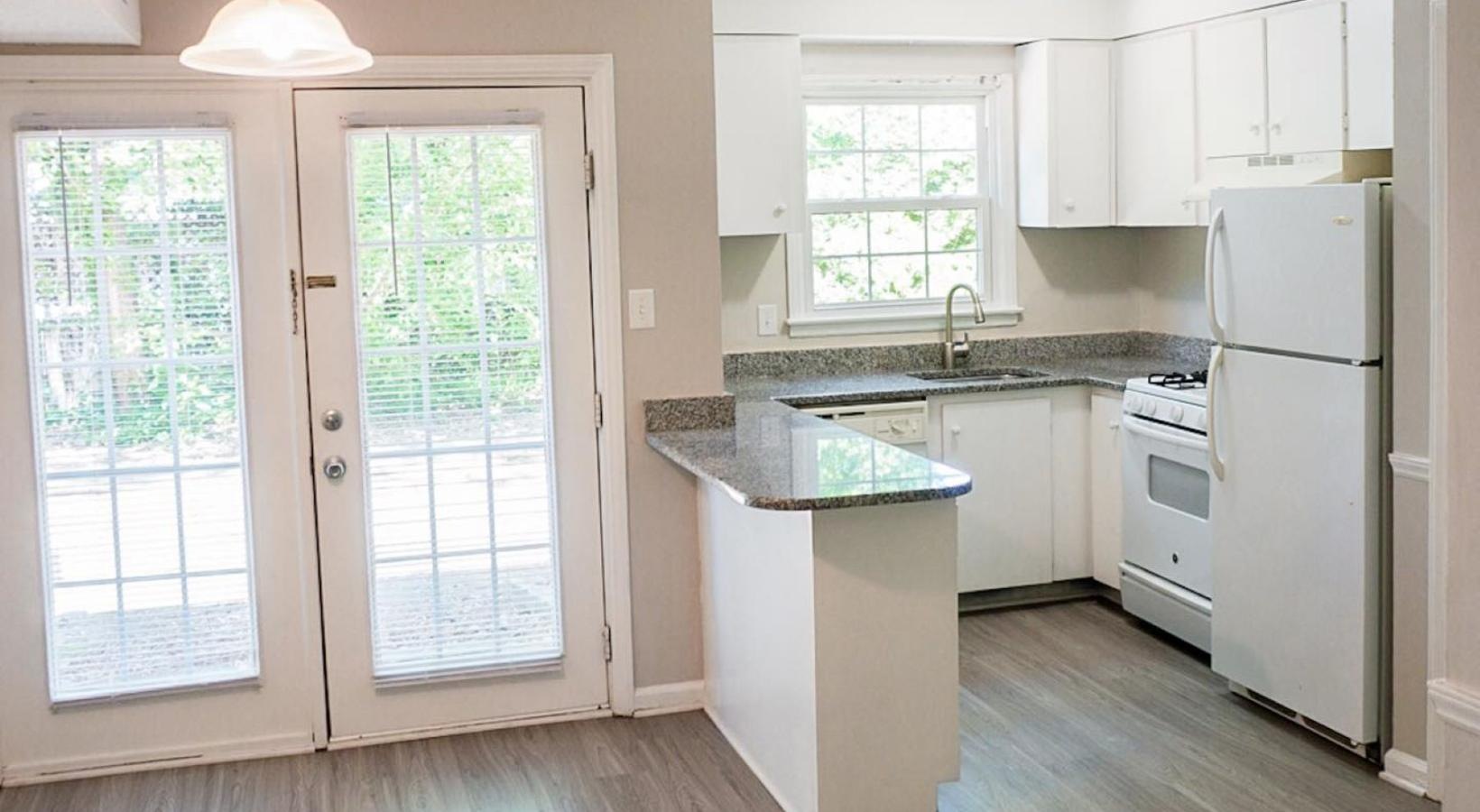 Spacious kitchens with thoughtful details a kitchen with white cabinets